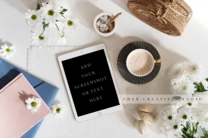 Tablet, Notebooks & Daisies. Styled Image.